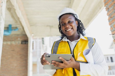 Photo for Portrait smart success black women worker african female work in construction industry happy smile in construction site. - Royalty Free Image