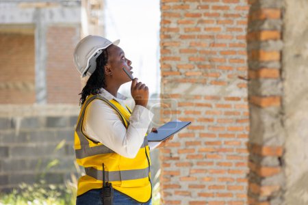 Photo for Engineer women black african professional worker working inspection quality check of construction site house building project. - Royalty Free Image