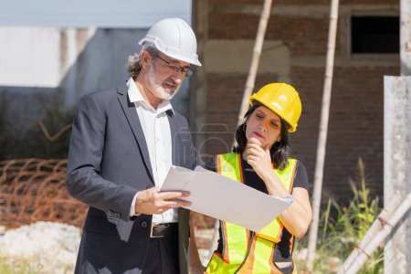 Photo for Senior professional architect consulting meeting talking with construction engineer women project manager review planing with floor plan design blueprint. - Royalty Free Image