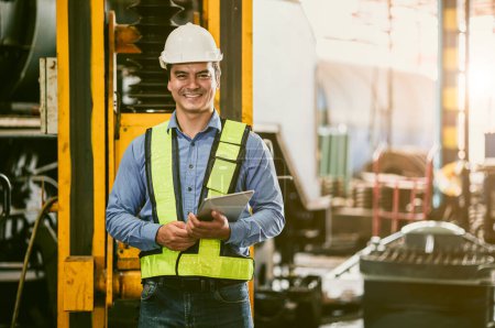Photo for Portrait happy adult senior engineer man officer in safety uniform standing happy smiling in heavy industry factory workplace hand holding tablet device. - Royalty Free Image