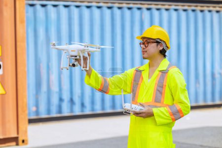 Photo for Staff worker using Drone aerial imaging system in port container yard. UAV Patrol flying guard technology for survey and security safety area in logistics cargo. - Royalty Free Image