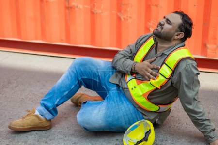 Photo for Heart attack chest pain expression. Hispanic indian fat male worker industry engineer staff accident fall down injury emergency need medical - Royalty Free Image