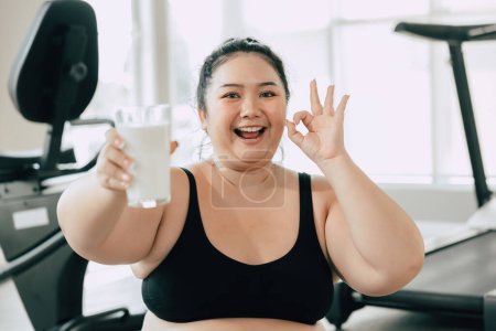 Photo for Sport healthy fat women happy smiling enjoy drink milk and diet exercise activity in fitness sport club - Royalty Free Image