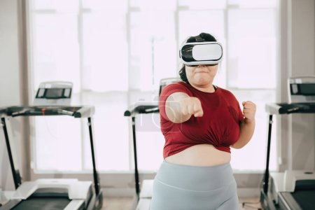 Photo for Fat women with VR headset play visual reality sport game for exercise. people using modern technology for healtcare concept. - Royalty Free Image