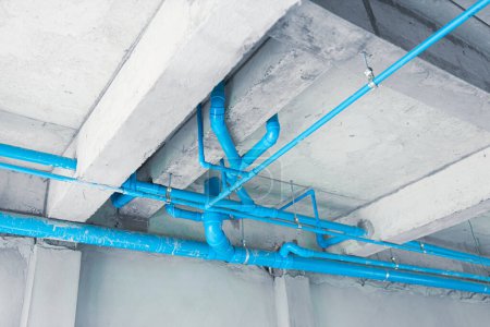 Photo for Pvc water blue plastic pipe installing at ground floor roof in under construction building - Royalty Free Image