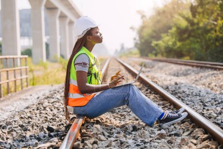 African black engineer women worker work checking service in train railway tracks construction site in transportation industry