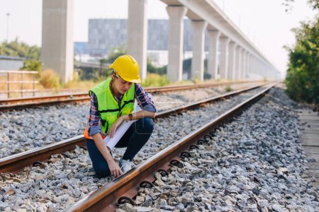 Engineer railway tracks construction service team working on site survey checking and maintenance inspection train track for safety