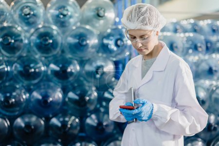 Senior women worker work in drink water factory counting check water bottle gallon stock in hygiene uniform workplace