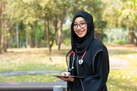 Photo for Saudi teen with stethoscope for high education arab women lifestyle in doctor school university campus nature background. - Royalty Free Image