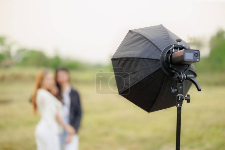 portable flash light setup with reflector modifier for portrait lighting outdoor photography