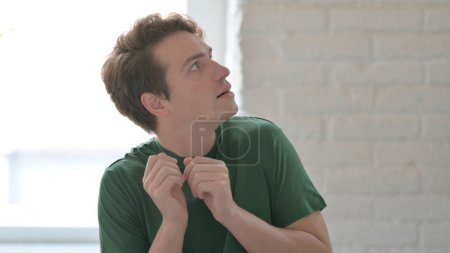 Photo for Frightened Casual Young Man Looking around in Fear - Royalty Free Image