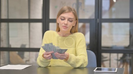 Photo for Happy Casual Creative Woman Counting Money in Office - Royalty Free Image