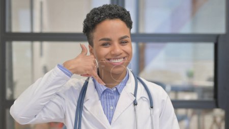 Call Me for Help Gesture by African Female Doctor