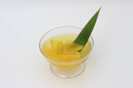 Photo for Glass of Candied Carica served fresh isolated on white background. Indonesian drinks and desserts. Carica or Manisan Carica. - Royalty Free Image