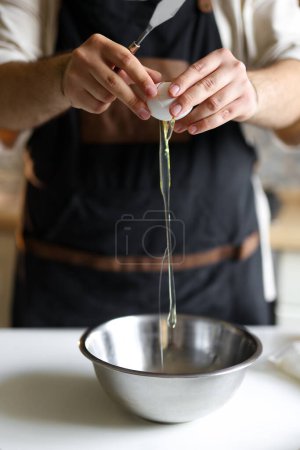 Photo for Confectioner prepares a cake, breaks an egg, dough preparation, step by step process. High quality photo - Royalty Free Image