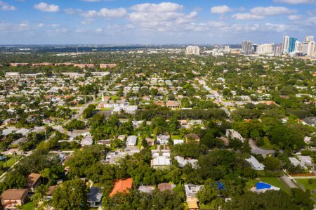 Aerial drone shot of elegant modern style houses in the Croissant Park neighborhood of Fort Lauderdale, tropical greenery around,
