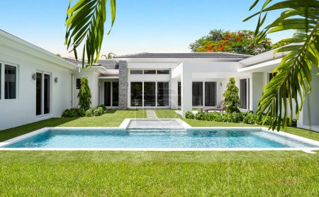 Hinterhof eines eleganten und modernen Hauses in Glenvar Heights, in Miami-Dade, weiße Wände, schwarze Fliesen, Glastüren, kurze Cepes, T-förmiger Pool, umgebende Bäume und Palmen, Sonnenliegen, blauer Himmel im Hintergrund
