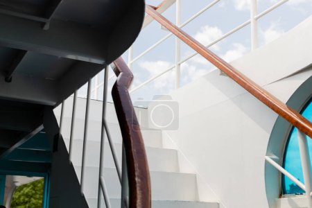 Railing and stairs of yacht and sky at background at daytime 