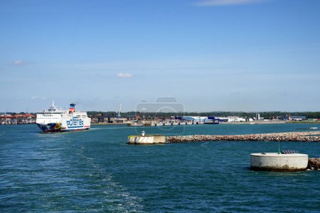 Photo for SWEDEN, YSTAD - CIRCA JULY 2022: Entrance to the port. Visible fairway of the ship and departing Polferries ferry. - Royalty Free Image
