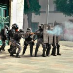 RIO DE JANEIRO, BRAZIL - Police officers shoot rubber bullets at striking protesters who were breaking public property in the city of Rio de Janeiro