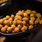 Roasted spicy chickpeas or Indian chana or chole, popular snack recipe. Healthy roasted seasoned chickpeas with spices inside a casserole dish