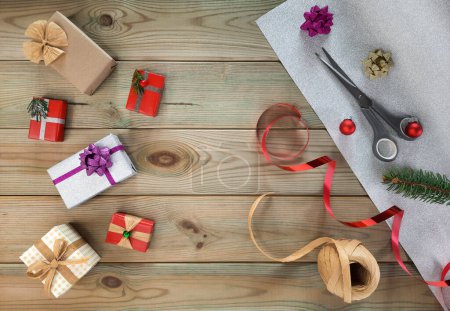 Gift decoration set. Concept of handiwork present wrapping. Flatlay. Materials for decorating gift boxes on wooden table. Top view. Various ideas for Christmas decoration. Goods for design