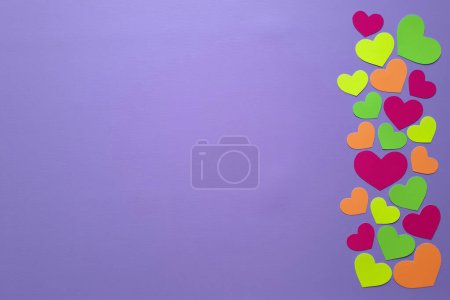 Photo for Bright layout with multi colored hearts for cover of notebook, notepad, advertising, card. Copy space. Top view. Delicate purple background and valentines cut out of paper. Space for text. Flat lay - Royalty Free Image
