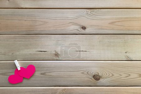 Photo for Composition with valentines for dating online, Valentine's Day February 14th. Copy space. Two pink hearts are connected with clothespin in left corner of wooden background. Flat lay. Space for text. - Royalty Free Image