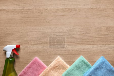 Photo for Set for wet cleaning, window cleaning, stain removal. Flat lay. Place for text. Cleaning spray and synthetic microfiber rags on wooden table background. Copy space. Top view. Housecleaning concept. - Royalty Free Image