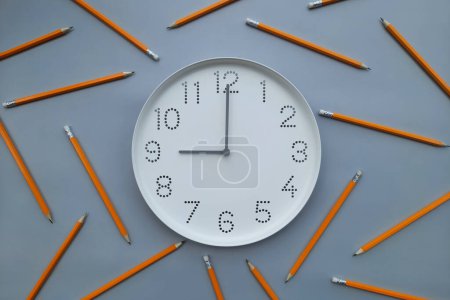 Photo for 9 o'clock, morning. Study time. Back to school. Watch with white clock face on blue table background with pencils. Concept of study, workday, deadline, schedule. New day. Beginning of week. - Royalty Free Image
