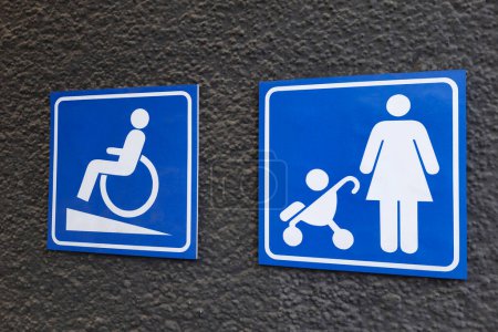 Foto de Símbolo de la persona en silla de ruedas y la madre con el niño en el cochecito de bebé en azul cuadrado. Concepto sin barreras. - Imagen libre de derechos