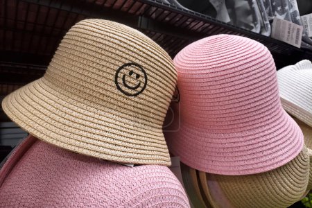 Photo for Summer accessories for sale. Two Straw Sun hats white and pink. Preparing for the summer season, vacation and choosing, buying new fashionable clothes - Royalty Free Image