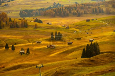 Photo for Golden alpine plains,Exciting morning scene of Compaccio village, Seiser Alm or Alpe di Siusi location, Bolzano province, South Tyrol, Italy, Europe. Fabulous summer sunrise of Dolomiti Alps. Traveling concept background. - Royalty Free Image