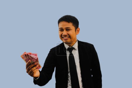 Adult Asian man smiling happy giving money