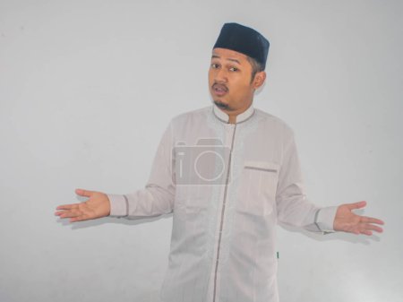 Téléchargez les photos : Musulman asiatique l'homme montrant confus expression lorsque essayer de décider quelque chose - en image libre de droit