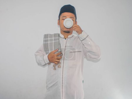 Moslem Asian man drinking a water