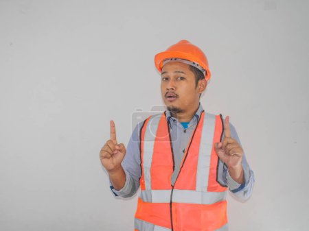 A man wearing construction socked expression with thumbs up pointing