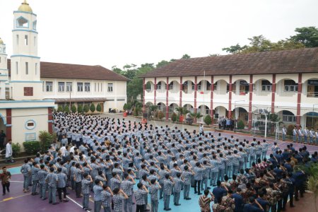Photo for Subang, Indonesia - May 2024: Middle school, high school students and teachers taking part in a ceremony to commemorate National Education Day on the school field - Royalty Free Image