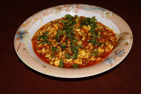 selective image of Brain masala is a spicy and flavorful South Asian dish  l cooked with onion, tomatoes, served with buns roti