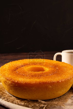 Foto de Yellow Brazilian Corn Cake (Bolo de Fuba) and coffee, vertical, copyspace, black background - Imagen libre de derechos