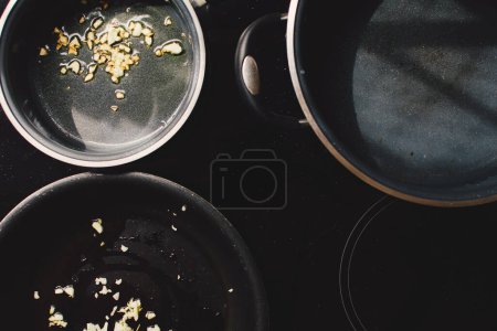 Photo for Frying garlic in frying pan, cooking at home, top view - Royalty Free Image