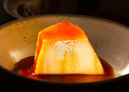 Photo for Creme Caramel Condensed Milk Pudim Slice with melting caramel in close up front view - Royalty Free Image