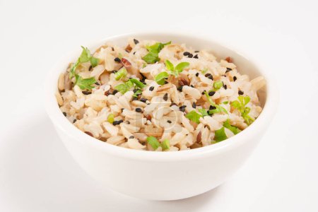 Whole rice inside a white ceramic bowl with sesame seeds isolated in white background in front view