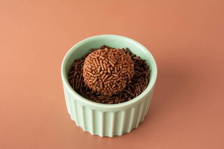 Schokolade Trüffelkugeln Brigadeiro brasilianische Bonbons und Schokoladenflocken Vorderseite grüne Schüssel