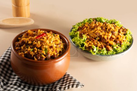 Baiao de Dois traditional Brazilian food with rice, beans, sausage and rennet cheese close
