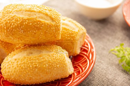 "French bread" with sesame seeds traditional Brazilian bread in a red plate