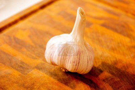 Garlic on a wooden board with dramatic lights