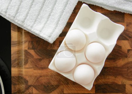 White chicken eggs in ceramic tray