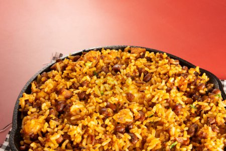 Baiao de Dois traditional Brazilian food with rice, beans, sausage and rennet cheese close up