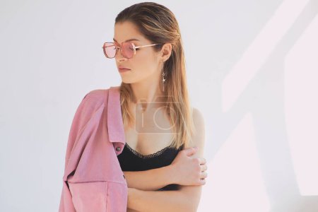 Photo for Portrait of young beautiful caucasian woman in dirty pink jacket and eye wear. Natural beauty, fashion, cosmetology - Royalty Free Image